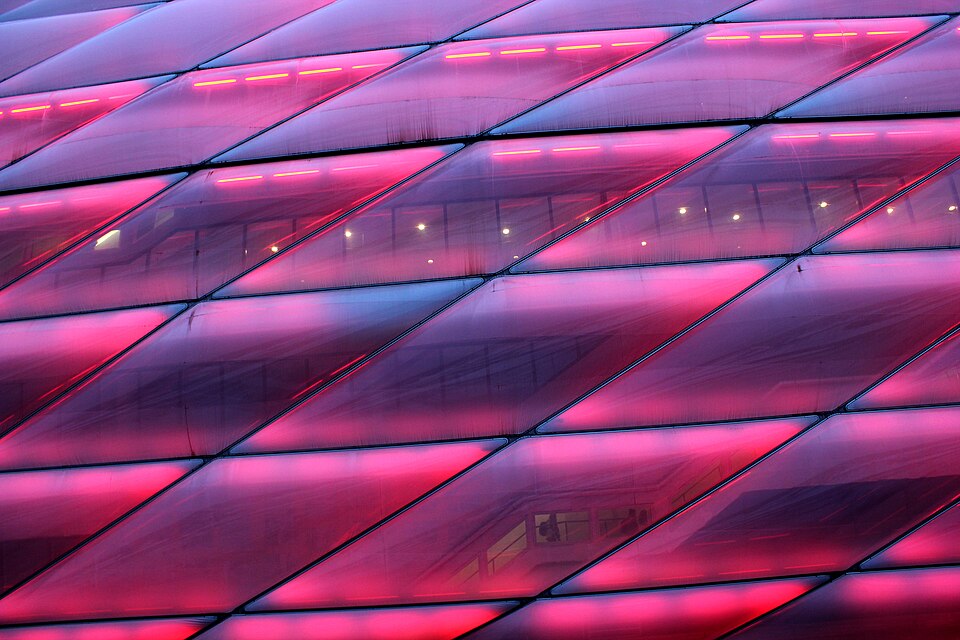 The Allianz Arena in Munich lit red, showing its quilted translucent facade panels