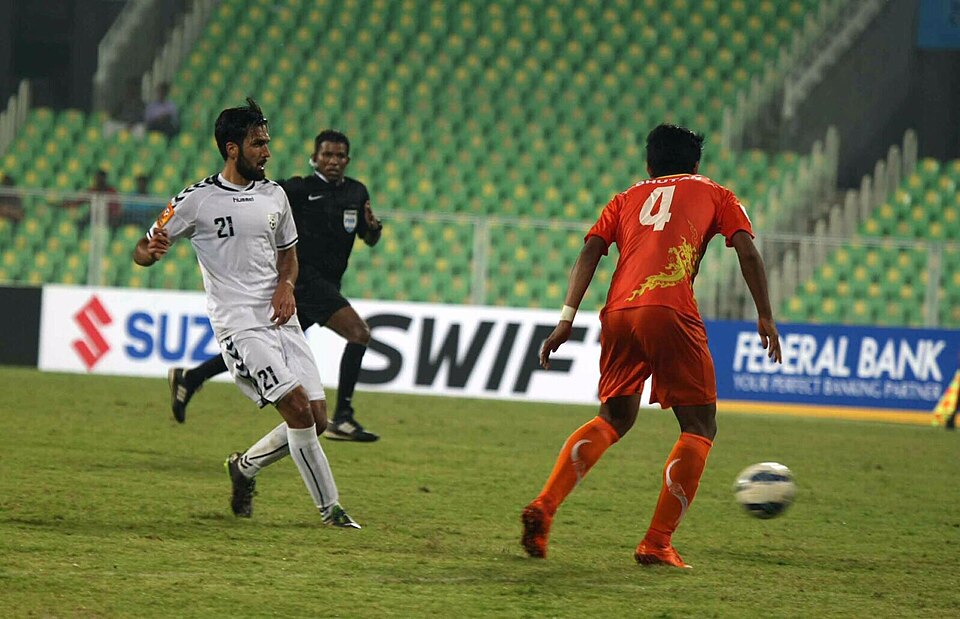 A footballer playing a pass during an international match