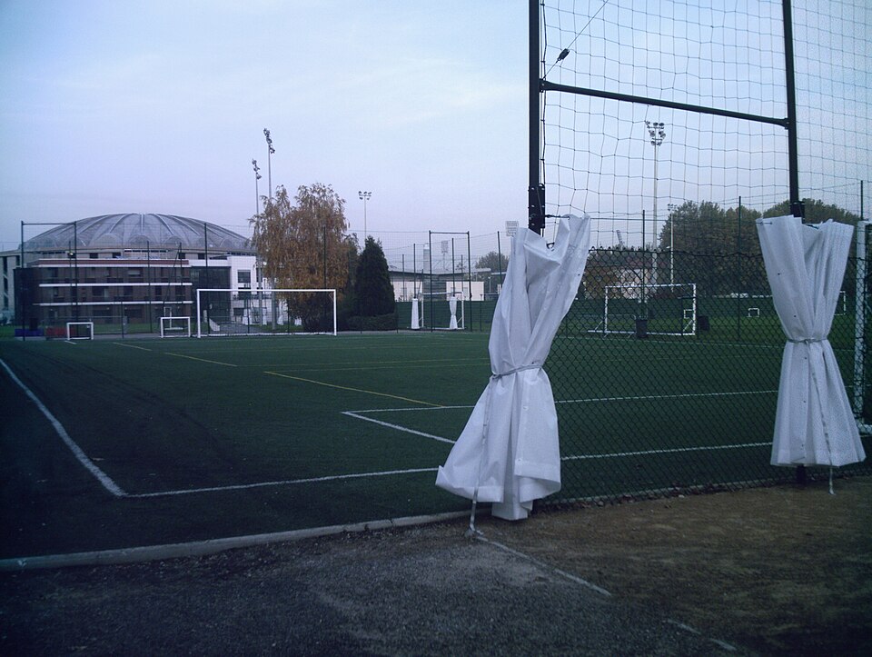 An artificial training pitch with goals, netting and floodlights at the Tola Vologe centre in Lyon